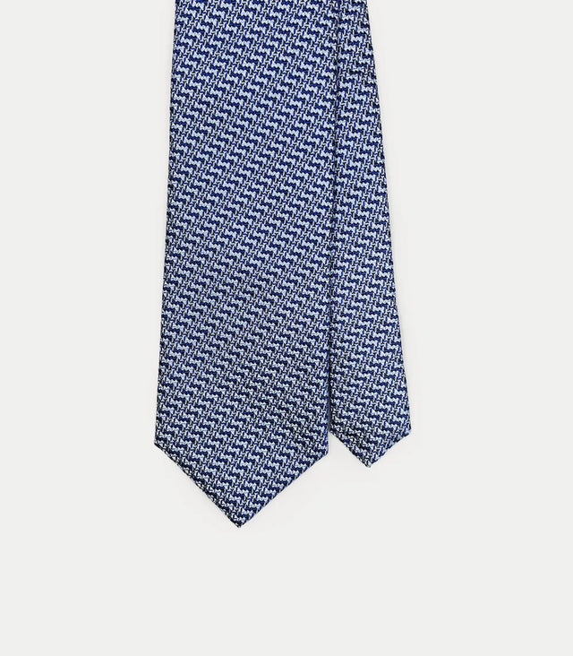 Cravatta lunga in seta blu con microfantasia geometrica bianca e azzurra