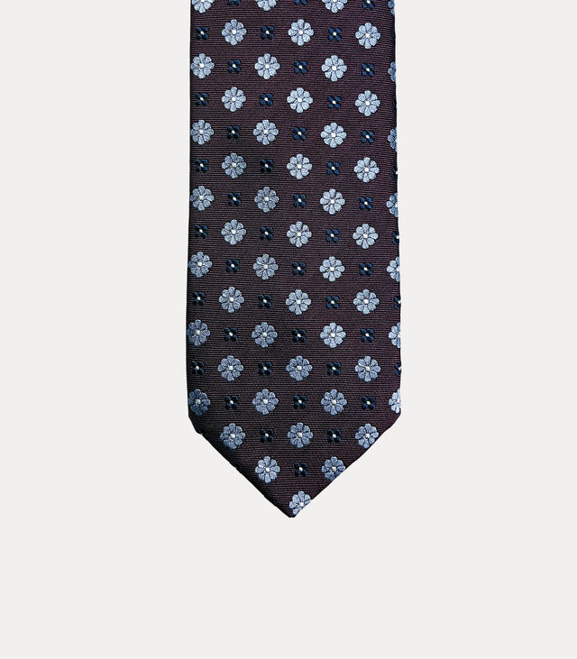 Cravatta uomo in seta 100% bordeaux scuro con microfiori azzurro ghiaccio e dettagli blu navy Fabio Toma Roma.
