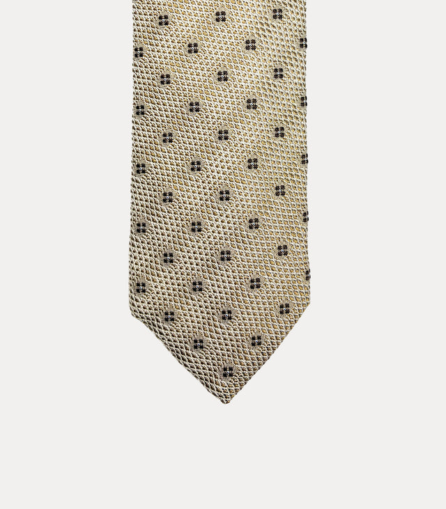 Cravatta Fabio Toma Q925 in 100% seta beige e avorio con piccoli fiori stilizzati marrone scuro.