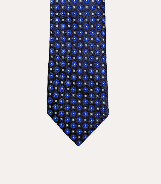 Cravatta uomo slim in seta 100% blu navy con microfiori blu elettrico e dettagli azzurri, larghezza 6 cm Fabio Toma Roma.