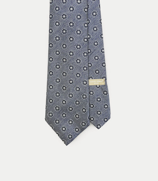 Cravatta blu cielo in seta jacquard con motivo floreale geometrico