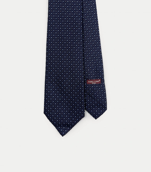 Cravatta blu scuro in seta jacquard con microdisegno puntinato