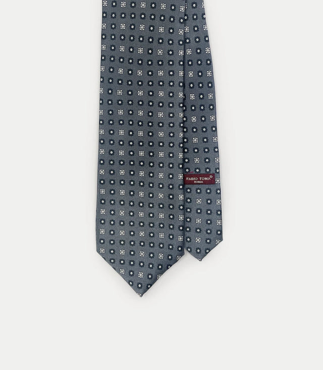 Cravatta grigio scuro in seta twill con motivo geometrico floreale bianco e blu
