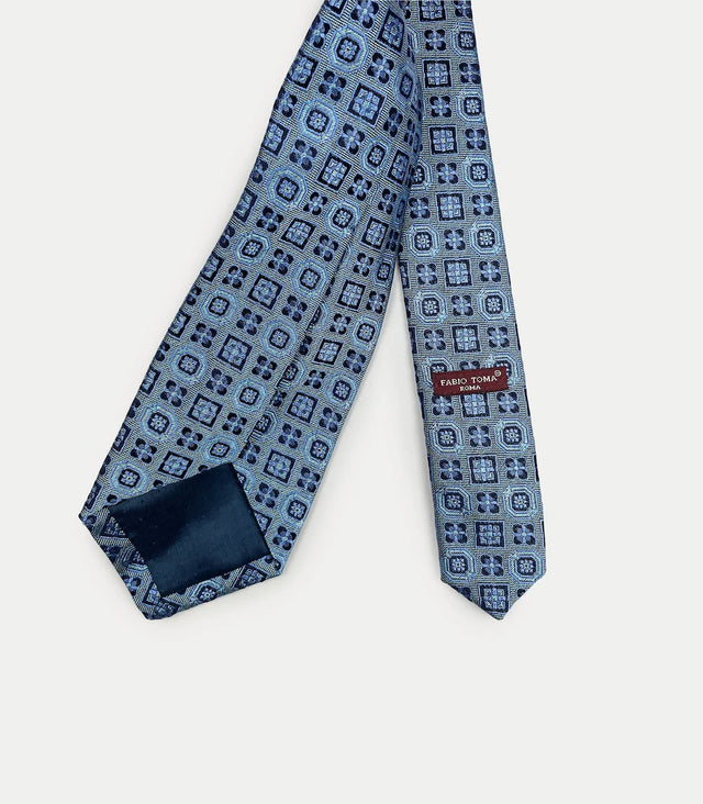 Retro cravatta azzurra con disegni geometrici in seta