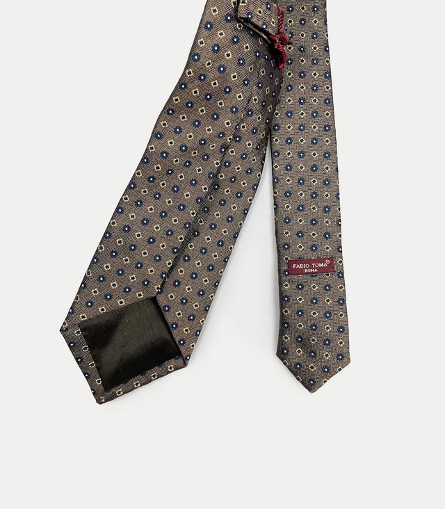 Retro cravatta marrone con disegni geometrici blu in seta