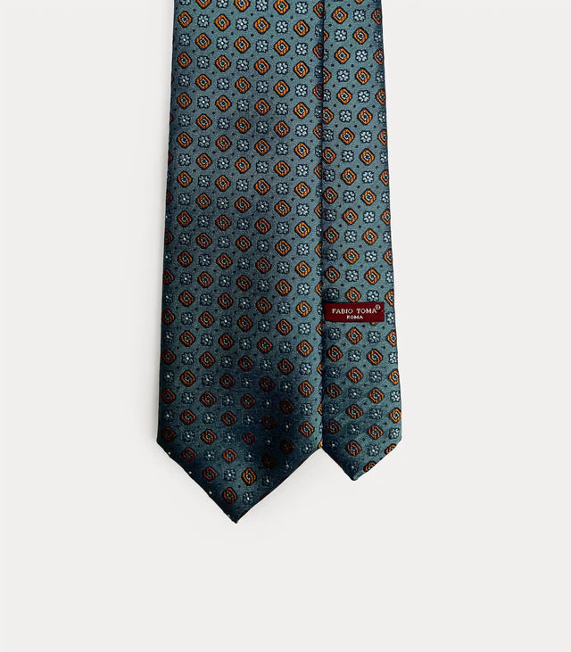 Cravatta Fabio Toma Roma ottanio in seta con motivo geometrico arancio e bronzo, fatta a mano.